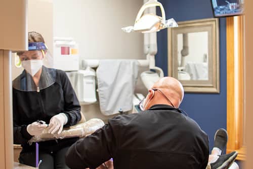 Cosmetic dentistry Dentist working on a patient with dental crowns