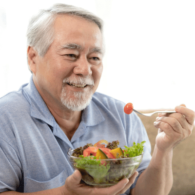 O'fallon dental works | cosmetic and general dentistry | dental care in o'fallon, mo 15 Older man enjoying a healthy salad bowl, representing what to eat for strong teeth and enamel