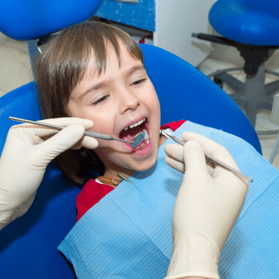 O'fallon dental works | cosmetic and general dentistry | dental care in o'fallon, mo 15 Child at dentist, smiling, representing oral health and speech development in children